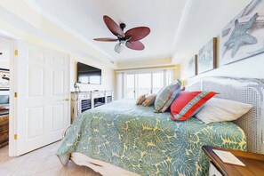 A bedroom with a bed, a ceiling fan, a window, and a door. - Bahia Vista I 403 (Ocean City)