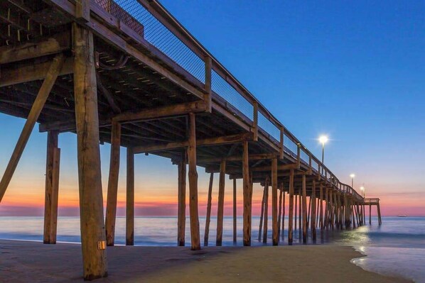 A wooden pier extending into the water with a clear sky above. - Waterfront condo with effortless beach access, private balcony, games, W/D, & AC (Ocean City)