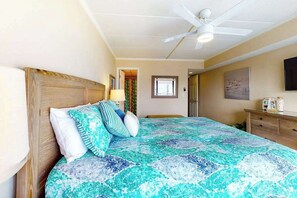 A bedroom with a bed, a ceiling fan, a dresser, a window, and a door. - Coastal Condo w/Side Ocean Views, Balcony, Shared Pool, Private W/D, Free WiFi (Ocean City)