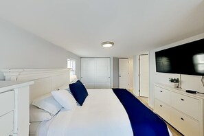 A hotel room with a bed, a TV, a dresser, and a closet. - Montego Bay Charmer with 2 Pools, Tennis & Putt-Putt - Walk to Beaches (Ocean City)