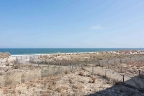 A sandy beach with a wooden fence and a clear view of the ocean. - Oceanfront Condo w/ Balcony, Great Views, NEW HVAC, W/D - Walk to Northside Park (Ocean City)