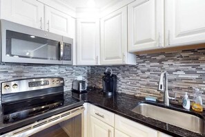 Fridge, microwave, oven, stovetop - Oceanfront Condo near the Boardwalk with Balcony, AC, WiFi & Shared Pool (Ocean City)