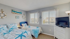 A bedroom with two beds, a TV, and a dresser. - Attractive & Convenient Vacation Home w/Private Washer/Dryer, Central AC, WiFi (Ocean City)