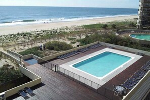 Ein Pool auf dem Dach mit Blick auf Strand und Meer.