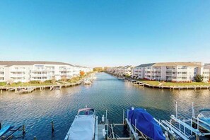 A canal view with a row of white buildings on either side. - Waterfront Condo on the Canal w/ Deck & Shared Pools/Tennis - Walk to the Beach (Ocean City)