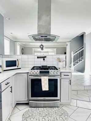 A modern kitchen with a built-in oven, microwave, and gas stove. - Spacious Dual-Home Retreat- Perfect for big family (Fayetteville)