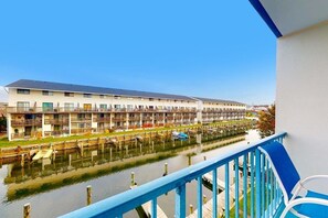A waterfront hotel with balconies, a dock, and a clear view of the water. - Blue Marlin 208 (Ocean City)