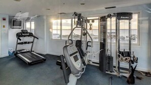 A gym with a treadmill, Nautilus equipment, and a view of the sea. - Astoria 204 (Ocean City)