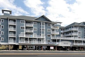 A multi-story hotel with balconies, a parking garage, and a sign indicating 'Office for Sale.' - 4100 #102 (Ocean City)