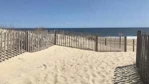 A sandy beach with a wooden fence and a clear view of the ocean. - High Point South 6C (Ocean City)