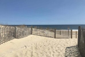 A sandy beach with a wooden fence and a clear view of the ocean. - High Point South 6C (Ocean City)