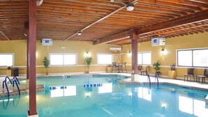 An indoor swimming pool with wooden beams, clear windows, and chairs. - Club Ocean Villa II 141 (Ocean City)