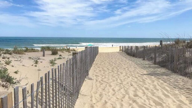 A sandy beach path leading to the ocean, with a wooden fence on one side and a clear view of the sea. - Club Ocean Villa II 141 (Ocean City)