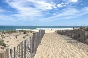 A sandy beach path leading to the ocean, with a wooden fence on one side and a clear view of the sea. - Club Ocean Villa II 141 (Ocean City)