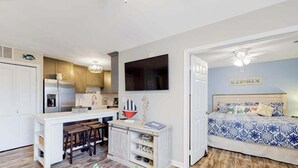 A compact living space with a kitchenette, a dining area, and a bedroom. - Club Ocean Villa II 141 (Ocean City)