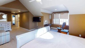A bedroom with a bed, a desk, a chair, a television, and a ceiling fan. - Quiet Family Home 4 Blocks from the Beach/Boardwalk with Deck, WiFi & Fireplace (Ocean City)