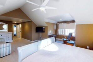 A bedroom with a bed, a desk, a chair, a television, and a ceiling fan. - Quiet Family Home 4 Blocks from the Beach/Boardwalk with Deck, WiFi & Fireplace (Ocean City)