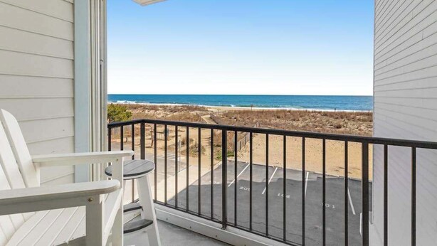 A balcony with a view of the beach and ocean. - Oceanfront Tide's Edge condo with balcony & boardwalk - walkable locale (Ocean City)