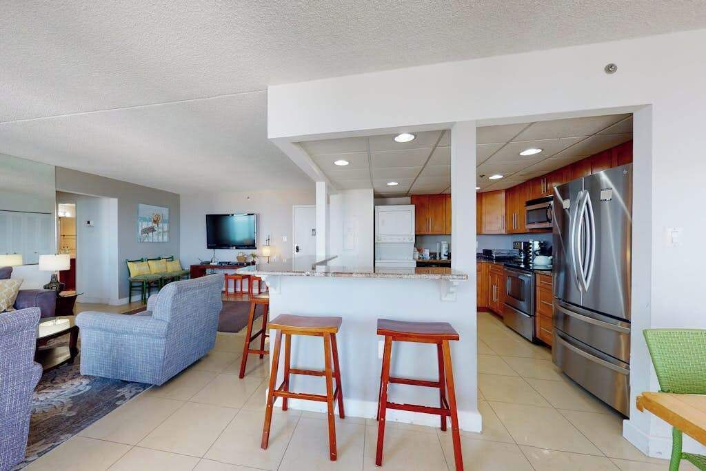 A modern apartment with a living room, kitchen, and dining area.