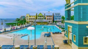A hotel with a pool, multiple balconies, and a view of the sea. - Sunset Island - 59 Island Edge (Ocean City)