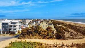 A coastal residential area with houses, a beach, and a clear sky. - Ocean Place 519 (Ocean City)