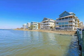 A waterfront hotel with multiple balconies, a clear view of the water, and a flat roof design. - Stylish, single-level condo with pools, a picnic area, & private beach access (Ocean City)