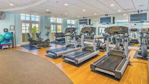 A gym with treadmills, elliptical machines, and exercise balls. - Coastal retreat with beach and shared pool - balconies, AC, & W/D (Ocean City)