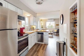 Fridge, microwave, oven, stovetop - Dog-friendly condo near beach with updated interior & private W/D (Ocean City)