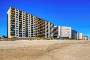 A multi-story hotel with a uniform facade, large windows, and a flat roof. - Marigot Beach 1207 (Ocean City)