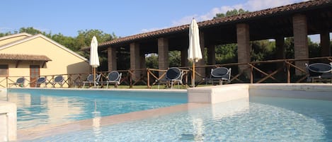 Seasonal outdoor pool, open 9:00 AM to 7:00 PM, pool umbrellas