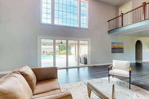A spacious living area with a large window, a balcony, and a view of the outdoors. - 3 Ladies Estate (Bishopville)