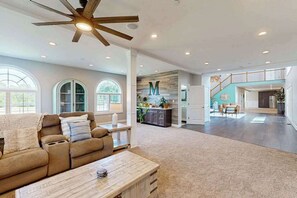 A spacious living room with a ceiling fan, a sofa, a coffee table, and a kitchen area in the background. - 3 Ladies Estate (Bishopville)