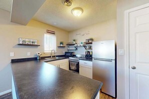 Fridge, microwave, oven, stovetop - Sunny - 3rd floor, spacious condo with kitchen, balcony & canal views (Ocean City)