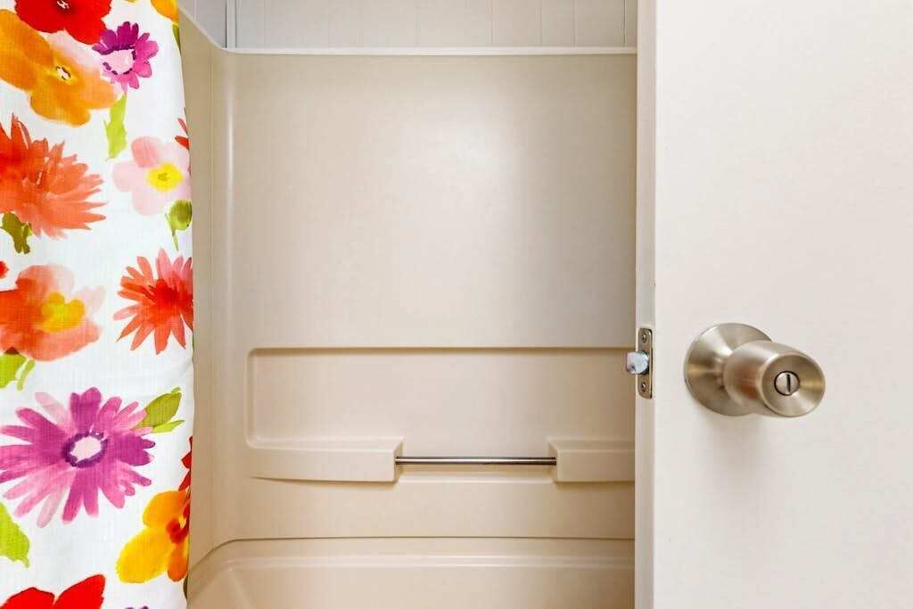 A door with a metallic lock and a beige handle.