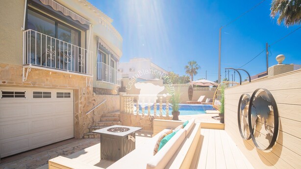 A wooden deck with a pool, outdoor furniture, and a garage. - CostaBlancaDreams - Casa Kaiyo in Calpe (Calpe / Calp)