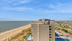 A high-rise hotel with a pool and beach view. - Stunning oceanfront condo w/ private balcony, beach access, pools & game rooms (Ocean City)