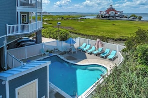 A residential property with a swimming pool, outdoor seating, and a view of the sea. - The View 402 (Ocean City)