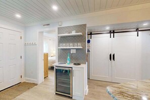 A modern kitchen with white cabinetry, a built-in oven, and a small refrigerator. - Tiffanie By The Sea 323D (Ocean City)