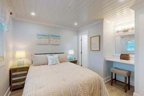 A bedroom with a bed, nightstands, a bench, a mirror, and wall art. - Tiffanie By The Sea 323D (Ocean City)