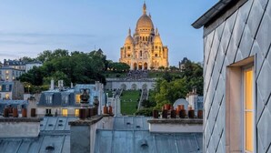A large, ornate building with a dome, surrounded by trees and other buildings. - celine 19  (Paris)
