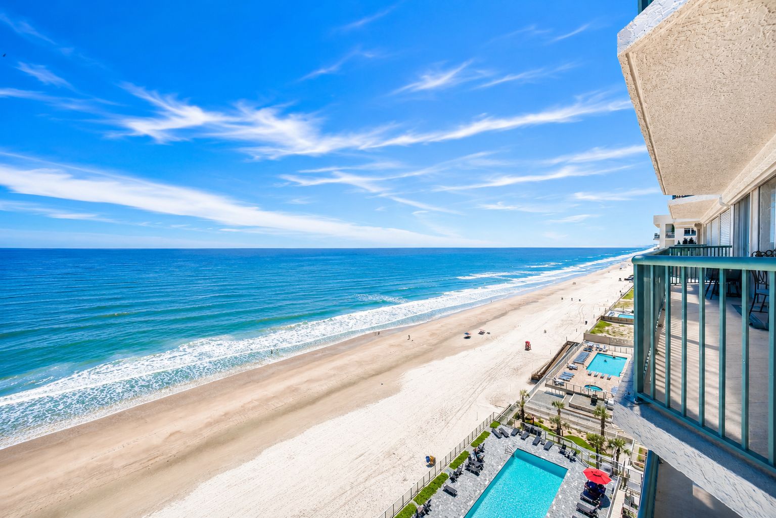 A beachfront hotel with a pool, beach access, and ocean views.