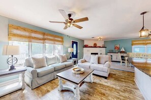 A living room with two sofas, a coffee table, and a ceiling fan. - Inviting home near beaches with fast WiFi, AC, full kitchen & W/D - dog-friendly (Ocean City)
