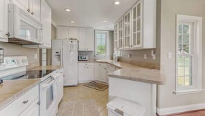 A kitchen with white cabinetry, a microwave, a refrigerator, and a built-in oven. - 4BR Coastal Getaway - Golf, Pool & OC Beach access in Berlin, MD (Berlin)