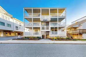 A multi-story building with balconies, a sign reading 'NORJO,' and a well-maintained exterior. - Spacious ocean view condo with large balcony & washer/dryer - easy beach access (Ocean City)
