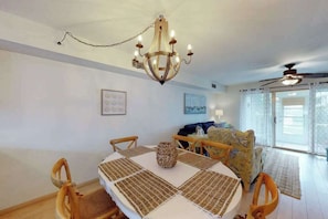 A dining area with a chandelier, round table, and chairs. - Townhome with central AC, washer/dryer, & pool access - close to beach (West Ocean City)