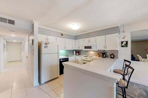 Fridge, microwave, oven, stovetop - Coastal condo with shared pool, balcony, open layout, internet, W/D, & AC (Ocean City)