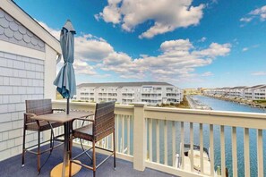 Outdoor dining - Sunny Waterfront Condo w/Canal Views, Balcony, Central AC, Shared Pool & Tennis (Ocean City)