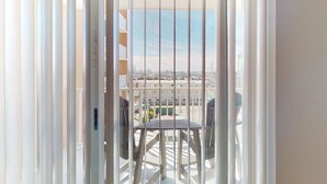 A balcony with a view of buildings and a clear sky. - Makai 403 (Ocean City)