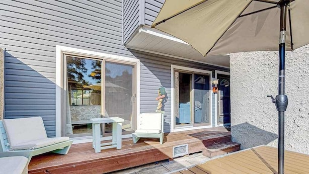 A covered deck with outdoor furniture, a table, and a chair. - Ground-floor condo with pool & fenced patio - 4 blocks to the beach (Ocean City)