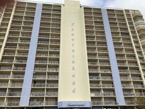 A high-rise building with a prominent vertical sign reading 'fountainhead.' - Fountainhead Towers 310 (Ocean City)